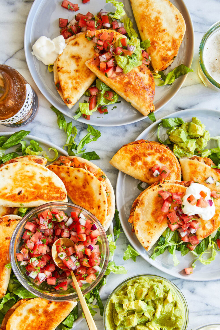 Mini Chicken Quesadillas - crowd-pleasing snack-sized quesadillas with refried beans, leftover rotisserie chicken + melted cheese!  So good!