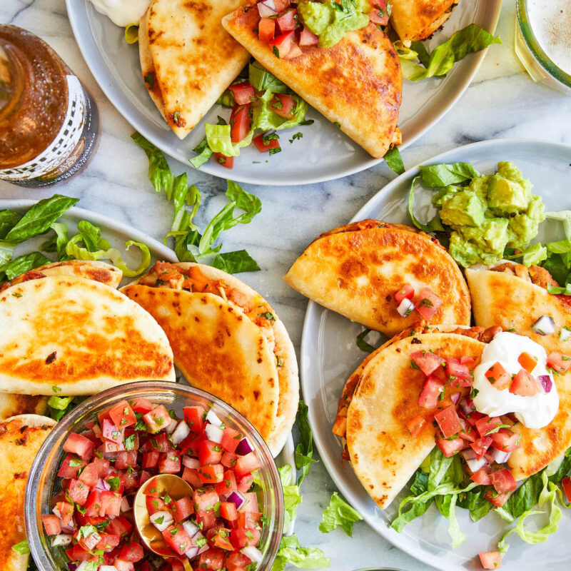 Snack-size quesadillas with refried beans, leftover rotisserie chicken, guacamole + melted cheese.