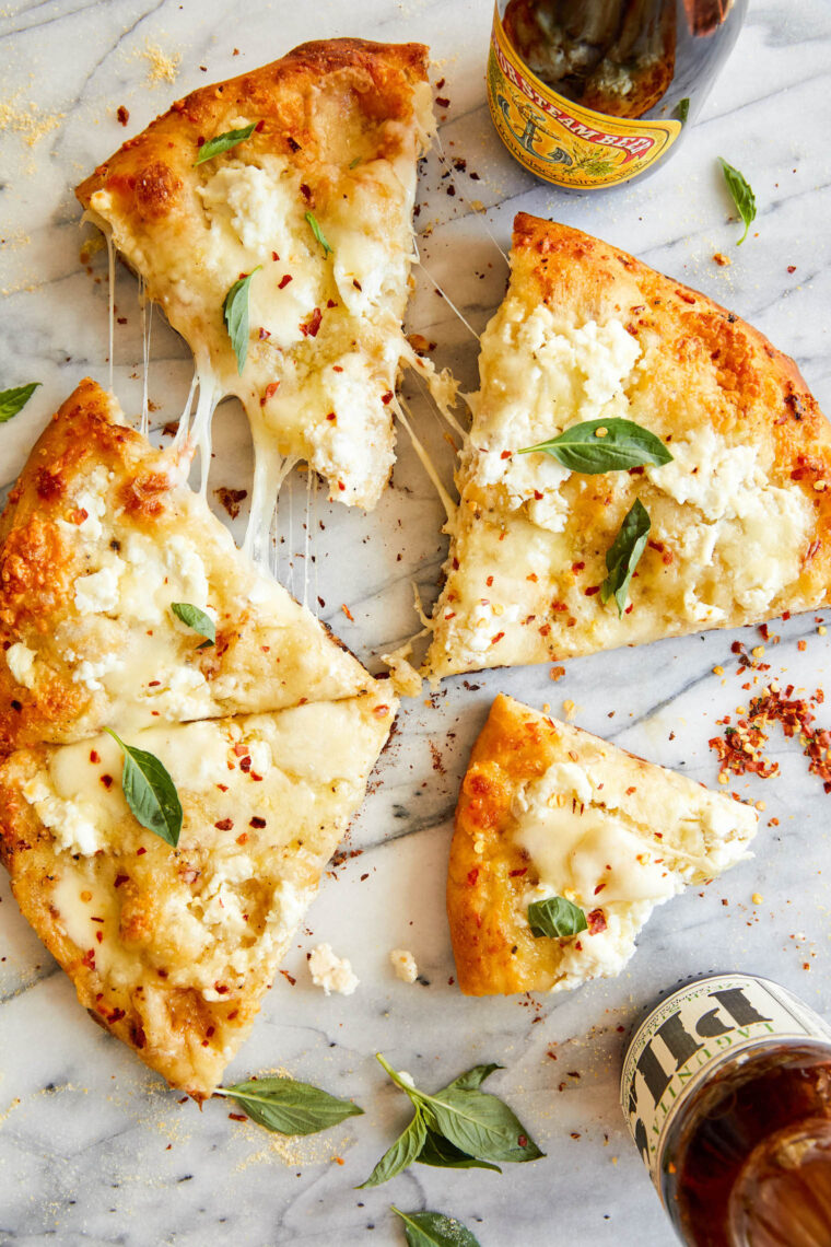 White Pizza - Made with 3 different cheeses (no tomato sauce here!) and drizzled with extra-virgin olive oil, garlicky goodness. Yes, please!