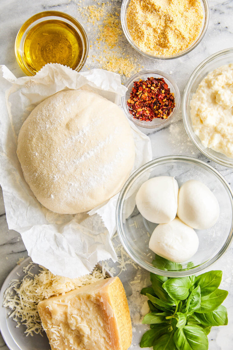 White Pizza - Made with 3 different cheeses (no tomato sauce here!) and drizzled with extra-virgin olive oil, garlicky goodness. Yes, please!