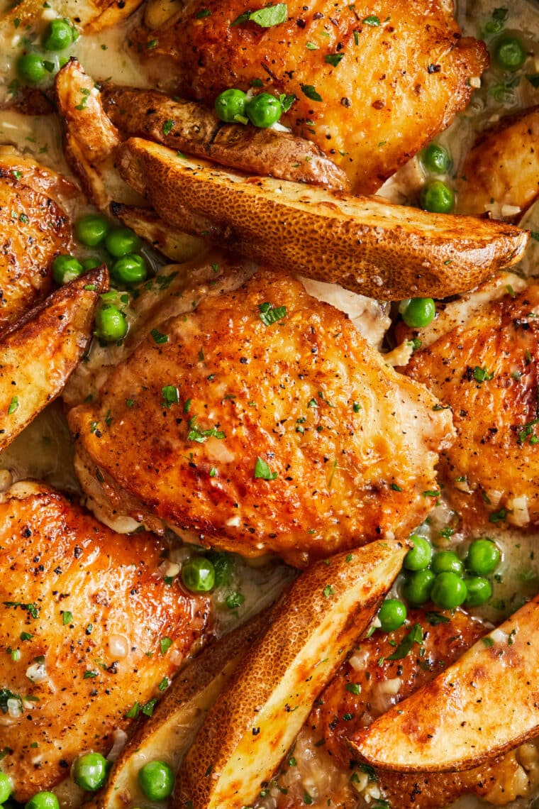 Chicken Vesuvio - Perfectly juicy chicken, peas and potatoes in THE BEST white wine sauce. Truly the best roast chicken dish there ever was.