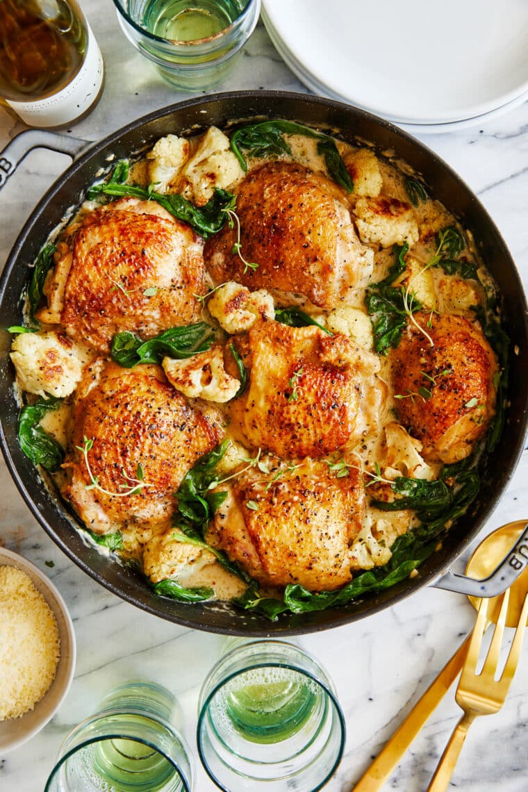 Creamy Chicken and Cauliflower - Tender, juicy golden brown chicken cooked in a creamy sauce from heaven with roasted cauliflower + baby spinach!
