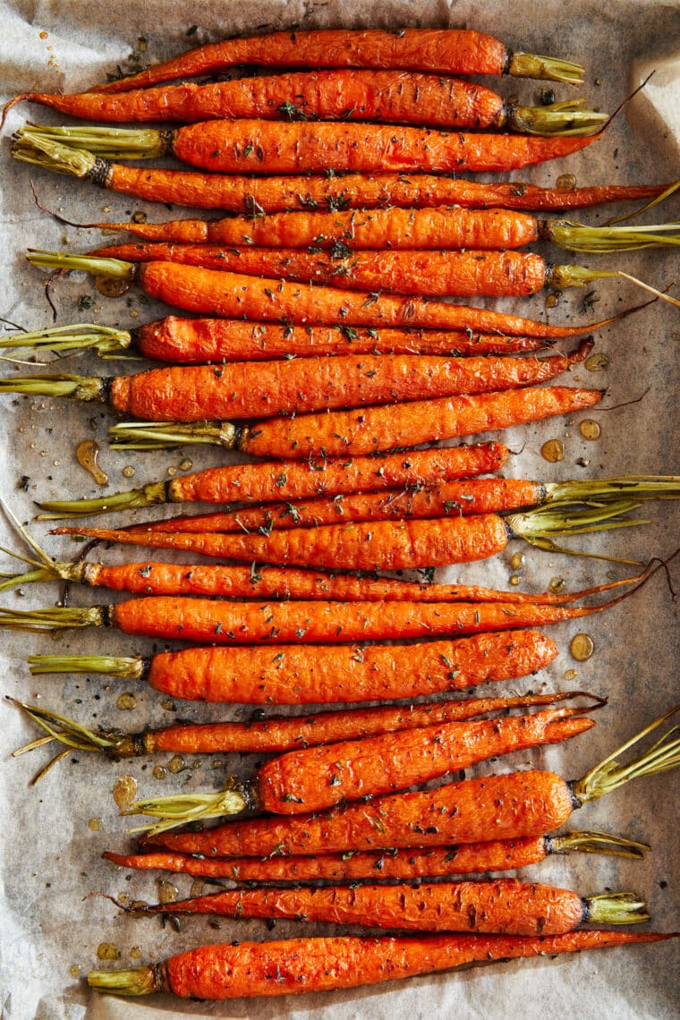 Glazed Carrots - Honey glazed carrots roasted to perfection, tossed in butter + fresh herbs. The easiest (and tastiest) side dish to any meal!