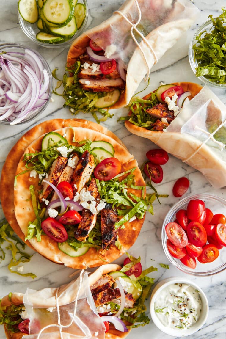 Sliced and cooked chicken shawarma pieces served on folded pita bread.