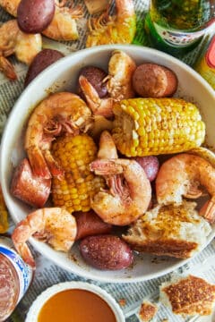 Unpeeled shrimp, corn, sausage, and baby potatoes cooked in a garlicky, lemony beer broth and served with bread.