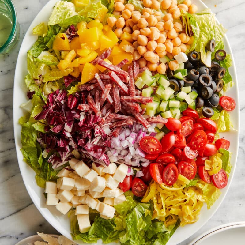 Lettuce, tomoratoes, cubed mozzarella, dry Italian salami, chickpeas, sliced olives, diced cucumber, pepper, and red onion.