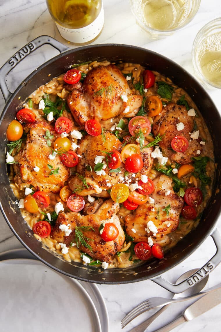 One Pot Greek Chicken and Orzo - Tender, juicy chicken and the creamiest orzo ever (that cooks right in the pan) topped with tomatoes + feta!