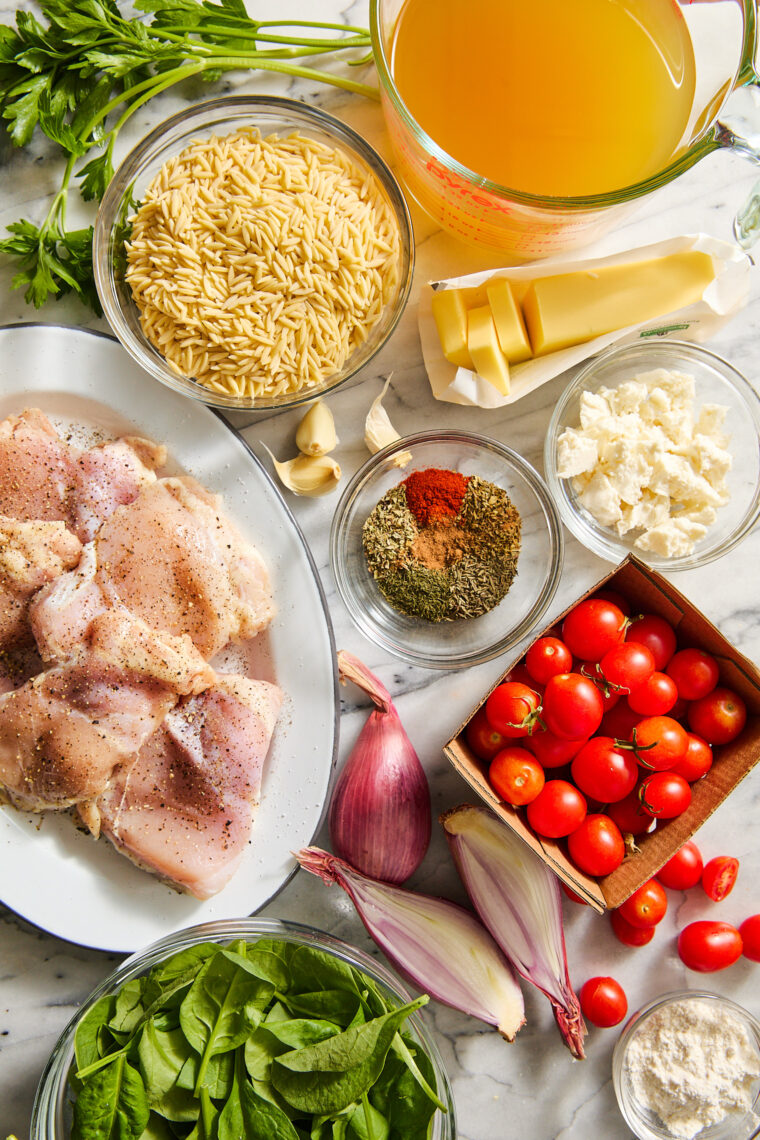 One Pot Greek Chicken and Orzo - Tender, juicy chicken and the creamiest orzo ever (that cooks right in the pan) topped with tomatoes + feta!