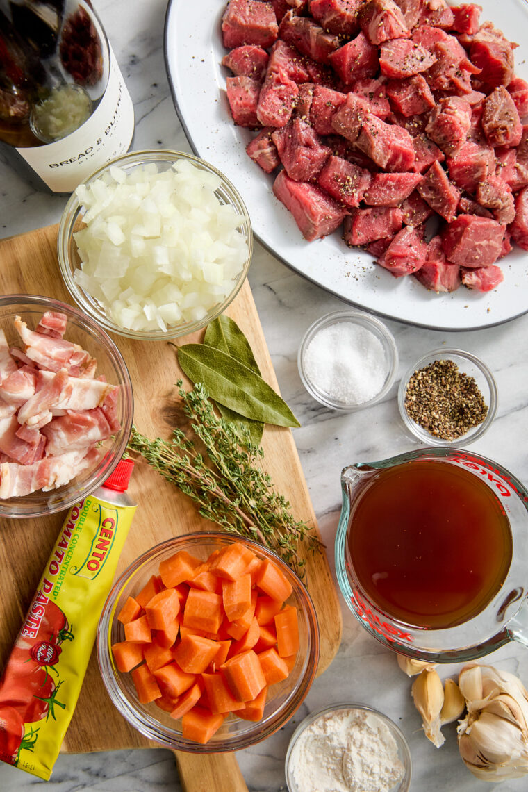 Easy Beef Bourguignon - A classic French stew with oh-so-tender braised fall apart beef with vegetables in a luxurious red wine gravy sauce.