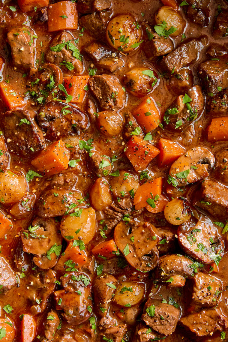 Easy Beef Bourguignon - A classic French stew with oh-so-tender braised fall apart beef with vegetables in a luxurious red wine gravy sauce.