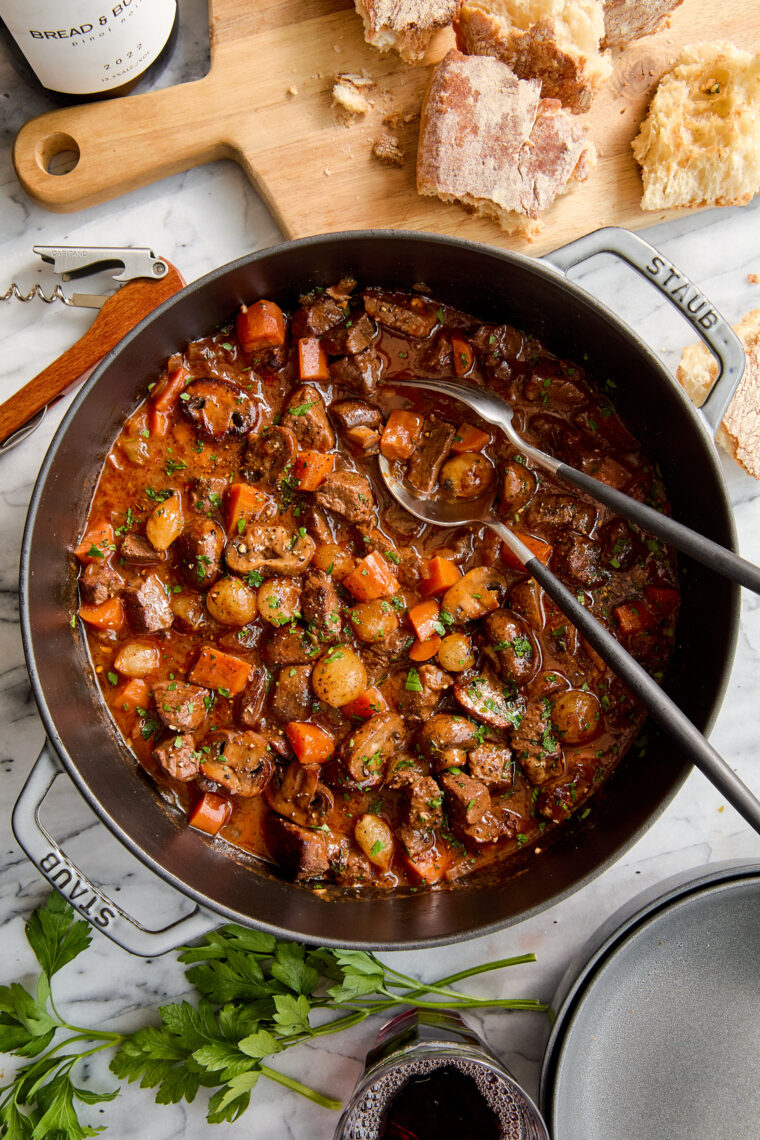 Easy Beef Bourguignon - A classic French stew with oh-so-tender braised fall apart beef with vegetables in a luxurious red wine gravy sauce.