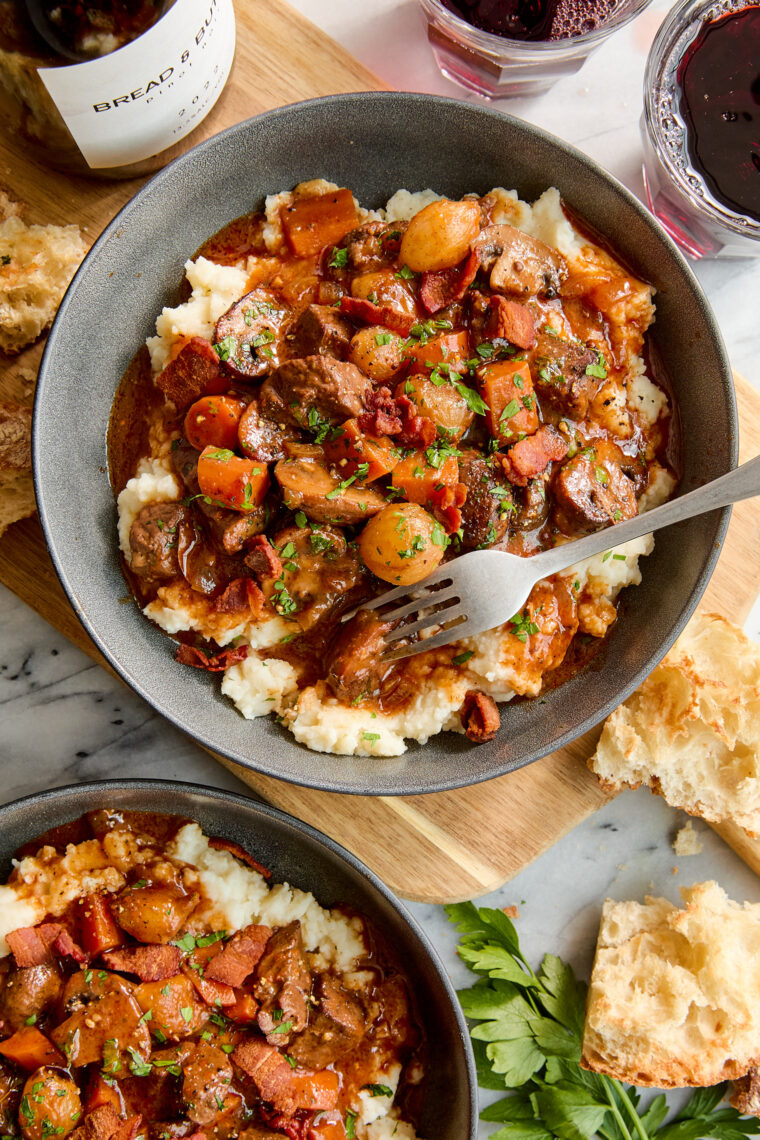 Easy Beef Bourguignon - A classic French stew with oh-so-tender braised fall apart beef with vegetables in a luxurious red wine gravy sauce.