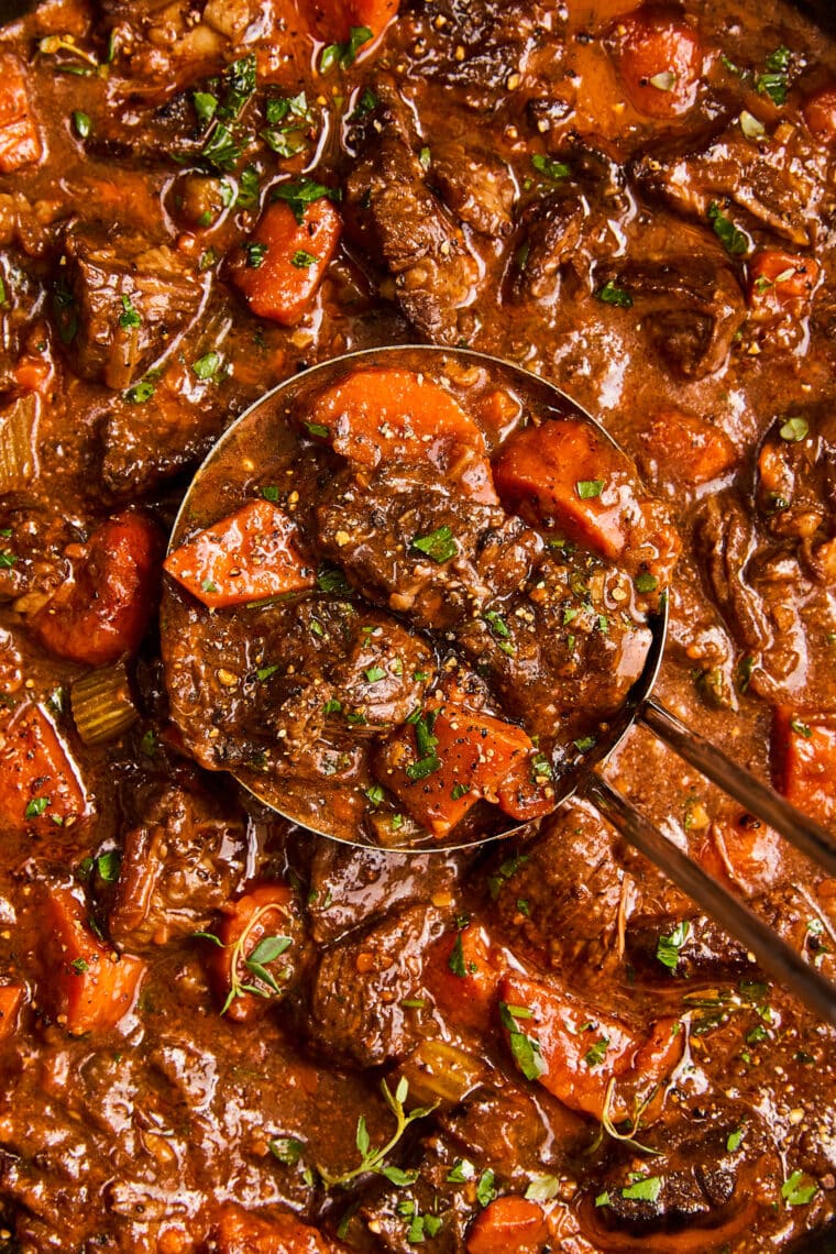 Guinness Beef Stew - A deep, rich beef stew so flavorful with veggies + the most tender fall-apart beef. Serve over mashed potatoes. So good!