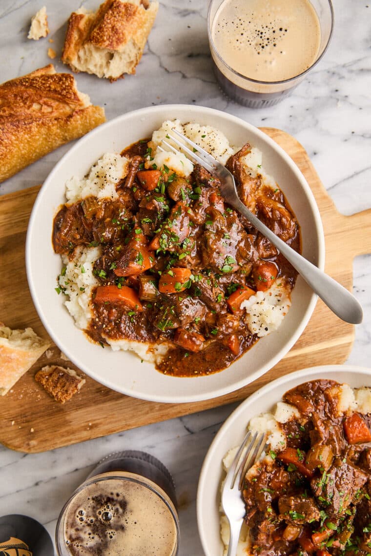 Guinness Beef Stew - A deep, rich beef stew so flavorful with veggies + the most tender fall-apart beef. Serve over mashed potatoes. So good!